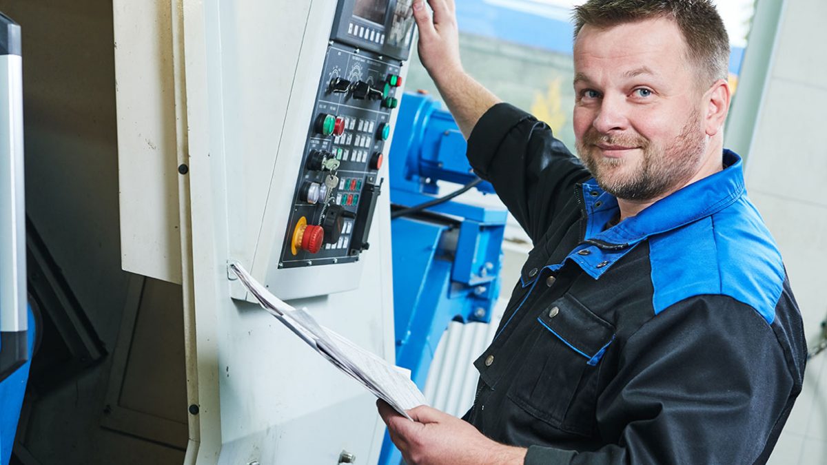 A CNC machinist at work